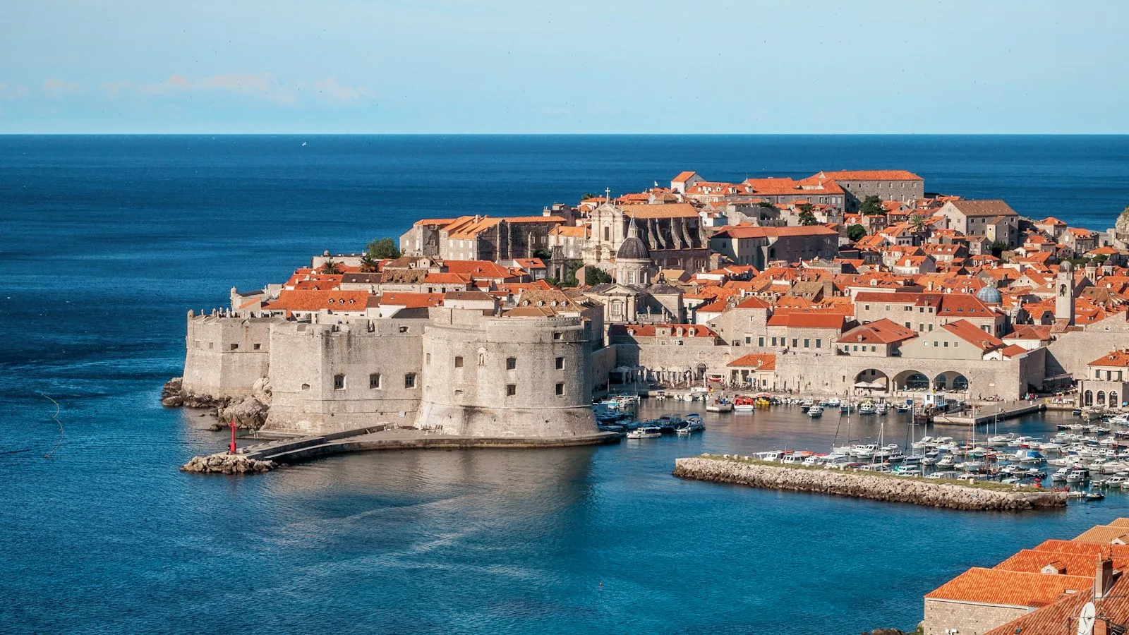 Panorámica de las murallas medievales, tejados rojizos de Dubrovnik y aguas turquesas del Adriático
